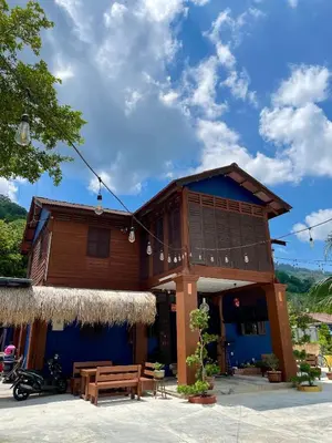a wooden building with a table and a bench at Kek Lok Si Inn in Ayer Itam