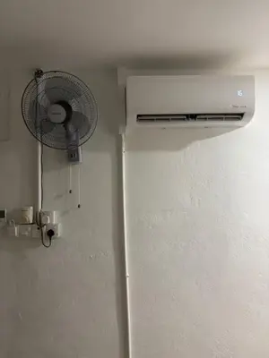 a white refrigerator with a fan in a room at Kek Lok Si Inn in Ayer Itam