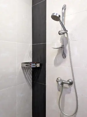 a shower with a shower head in a bathroom at The Retreat Mountain & Sunrise view Hilltop Hotel Apartment in Cameron Highlands in Cameron Highlands
