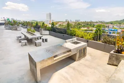 a view from the roof of a building with tables and benches at Marc CoLiving by Cobytat in Bukit Mertajam