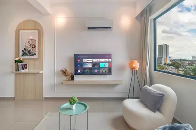 a living room with a tv and a chair and a window at Marc CoLiving by Cobytat in Bukit Mertajam