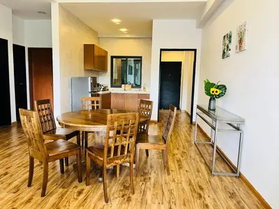a kitchen and dining room with a wooden table and chairs at Nova Sunrise & Mountain view Hilltop in Cameron Highlands in Brinchang