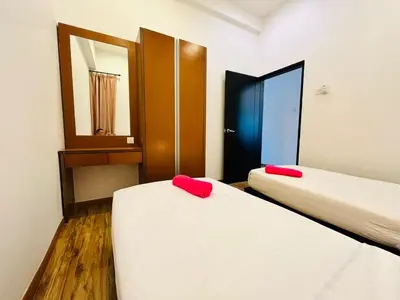 two beds in a room with two red pillows at Nova Sunrise & Mountain view Hilltop in Cameron Highlands in Brinchang