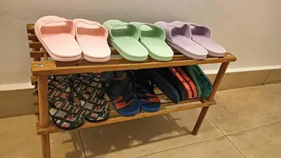 a wooden shelf with a bunch of shoes on it at Nova Sunrise & Mountain view Hilltop in Cameron Highlands in Brinchang