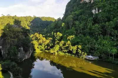 a river with a house in the middle of a mountain at Magnificent Mountain & Lake Views' Suite Cycas in Kampong Batu Lapan