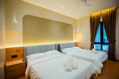 a bedroom with two beds with white sheets at Ipoh Modern Luxury House 4B3B 14 pax in Kampong Baharu Ampang
