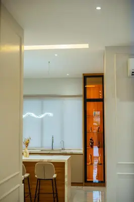 a kitchen with a sink and a counter with two chairs at Ipoh Modern Luxury House 4B3B 14 pax in Kampong Baharu Ampang