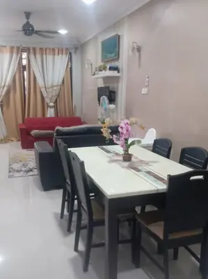 a living room with a table and chairs and a couch at Reisya Homestay in Kepala Batas