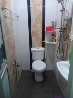 a small bathroom with a toilet and a sink at Reisya Homestay in Kepala Batas
