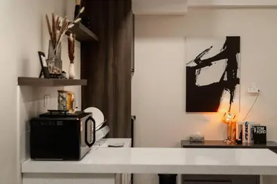 a kitchen with a counter top with a microwave at Modern Minimalist Home Retreat near Lake Garden in Taiping