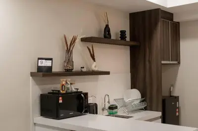 a kitchen with a counter top with a microwave at Modern Minimalist Home Retreat near Lake Garden in Taiping