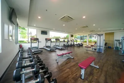 a gym with several treadmills and machines in a room at The Light Hotel Penang in Perai