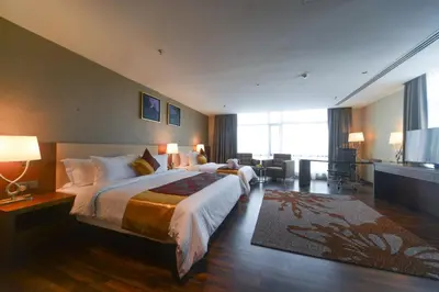 a hotel room with a large bed and a television at The Light Hotel Penang in Perai