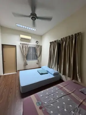 a bedroom with a bed in a room with a ceiling at Family choice Ling53 in Sitiawan
