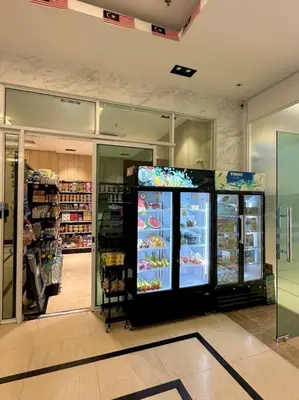 a grocery store aisle with a refrigerator in a store at Mansion One Modern 5pax walking distance Gleneagles Hospital Gurney Plaza in George Town