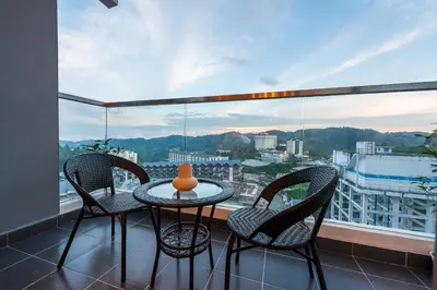 a table and chairs on a balcony with a view at Serene Zen Family Retreat 2 to 7pax&Sunrise View in Brinchang