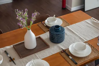 a table with plates and a vase with flowers on it at Serene Zen Family Retreat 2 to 7pax&Sunrise View in Brinchang