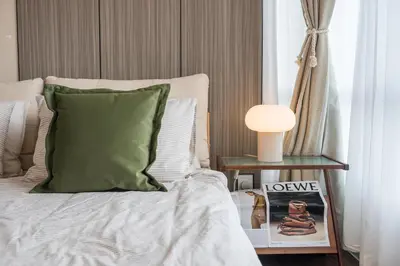 a bed with a green pillow and a side table at Serene Zen Family Retreat 2 to 7pax&Sunrise View in Brinchang