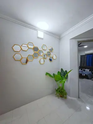 a white room with a wall with a sculpture on it at Homestay Last World Tambun in Kampong Batu Lapan