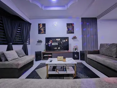 a living room with a couch and a tv at Homestay Last World Tambun in Kampong Batu Lapan
