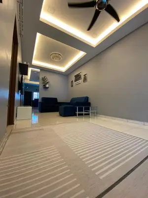 a living room with a ceiling fan and a couch at Teratak Raffa Homestay in Kampong Tebing Rabak