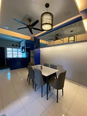 a dining room with a table and chairs and a ceiling fan at Teratak Raffa Homestay in Kampong Tebing Rabak