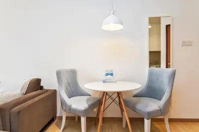 a living room with a table and two chairs at 118 Island Plaza Penang in Tanjong Tokong