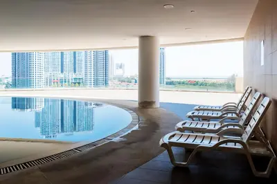 a row of chairs sitting next to a swimming pool at 118 Island Plaza Penang in Tanjong Tokong
