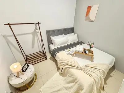 a bedroom with two beds and a mirror at Manhattan Suites Ipoh in Kampong Makam