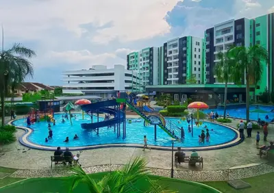 a water park in a city with people in it at Manhattan Suites Ipoh in Kampong Makam