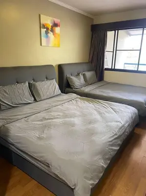a bedroom with two beds and a window at Brinchang Cameron 2R2B 10 paxs Copthorne KeaFarm #15407 in Brinchang