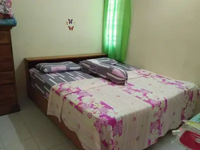 two suitcases are sitting on top of a bed at M4R Homestay Gua Musang in Kampong Batu Papan