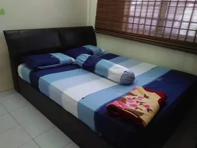 a bed with pillows on it in a room at M4R Homestay Gua Musang in Kampong Batu Papan