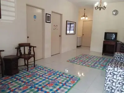 a living room with a couch and two rugs on the floor at M4R Homestay Gua Musang in Kampong Batu Papan