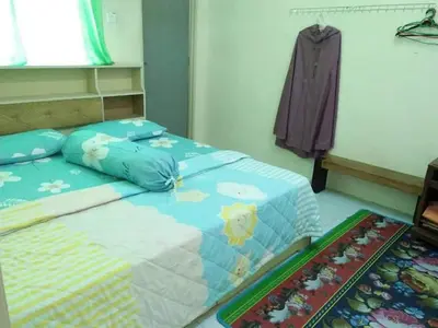 a bedroom with a bed with blue sheets at M4R Homestay Gua Musang in Kampong Batu Papan