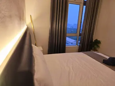 a bedroom with a white bed and a window at Helena Homes - Premium Cozy Ipoh Homestay in Kampong Simee