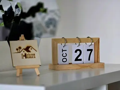 a table with a clock and a sign on a table at Helena Homes - Premium Cozy Ipoh Homestay in Kampong Simee