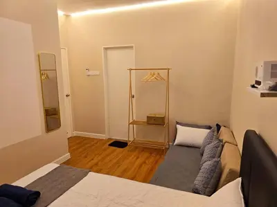 a living room with a bed and a couch at Helena Homes - Premium Cozy Ipoh Homestay in Kampong Simee