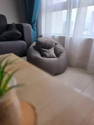 a dog bed sitting in a living room with a window at Helena Homes - Premium Cozy Ipoh Homestay in Kampong Simee