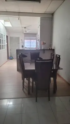 a dining room with a table and chairs at Ummi Homestay in Kampong Batu Tiga