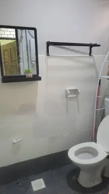 a bathroom with a toilet and a window at Ummi Homestay in Kampong Batu Tiga