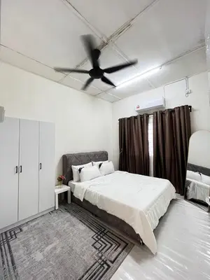 a bedroom with a bed and a ceiling fan at D'Farah Homestay Teluk Intan 3Bilik in Teluk Intan