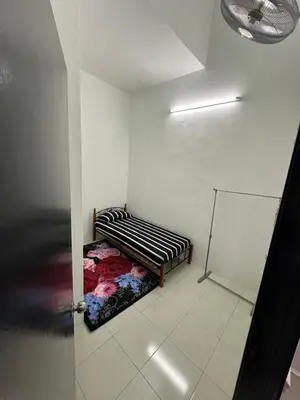 a room with a bench in the corner of a room at Homestay Warisan Taiping in Kampong Melayu Changkat Larah