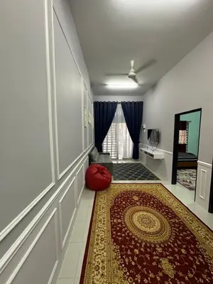 a living room with a red couch and a red rug at Homestay Warisan Taiping in Kampong Melayu Changkat Larah