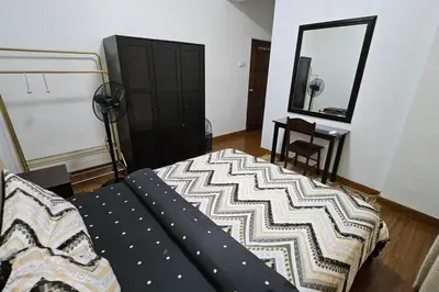 a bedroom with a bed and a mirror at Near USM 6 pax, 2 Bedroom w Aircond, 2 toilet, 5G WIFI in Si Dua Besar