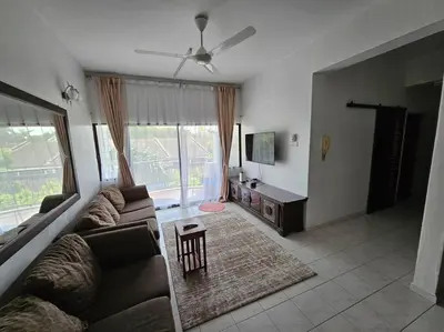 a living room with a couch and a tv at Near USM 6 pax, 2 Bedroom w Aircond, 2 toilet, 5G WIFI in Si Dua Besar