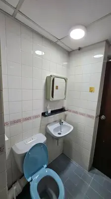 a bathroom with a blue toilet and a sink at Near USM 6 pax, 2 Bedroom w Aircond, 2 toilet, 5G WIFI in Si Dua Besar