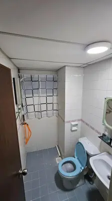 a bathroom with a blue toilet and a sink at Near USM 6 pax, 2 Bedroom w Aircond, 2 toilet, 5G WIFI in Si Dua Besar