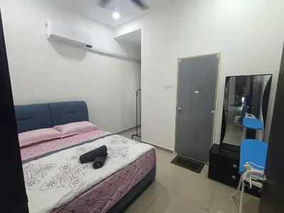 a bedroom with a bed with a black shoe on it at Homestay Coway Bertam in Kampong Sungai Korok