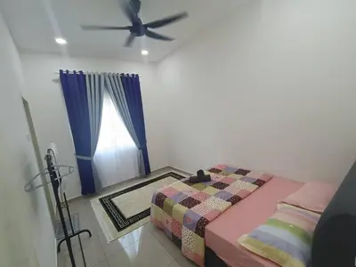a bedroom with a bed and a ceiling fan at Homestay Coway Bertam in Kampong Sungai Korok